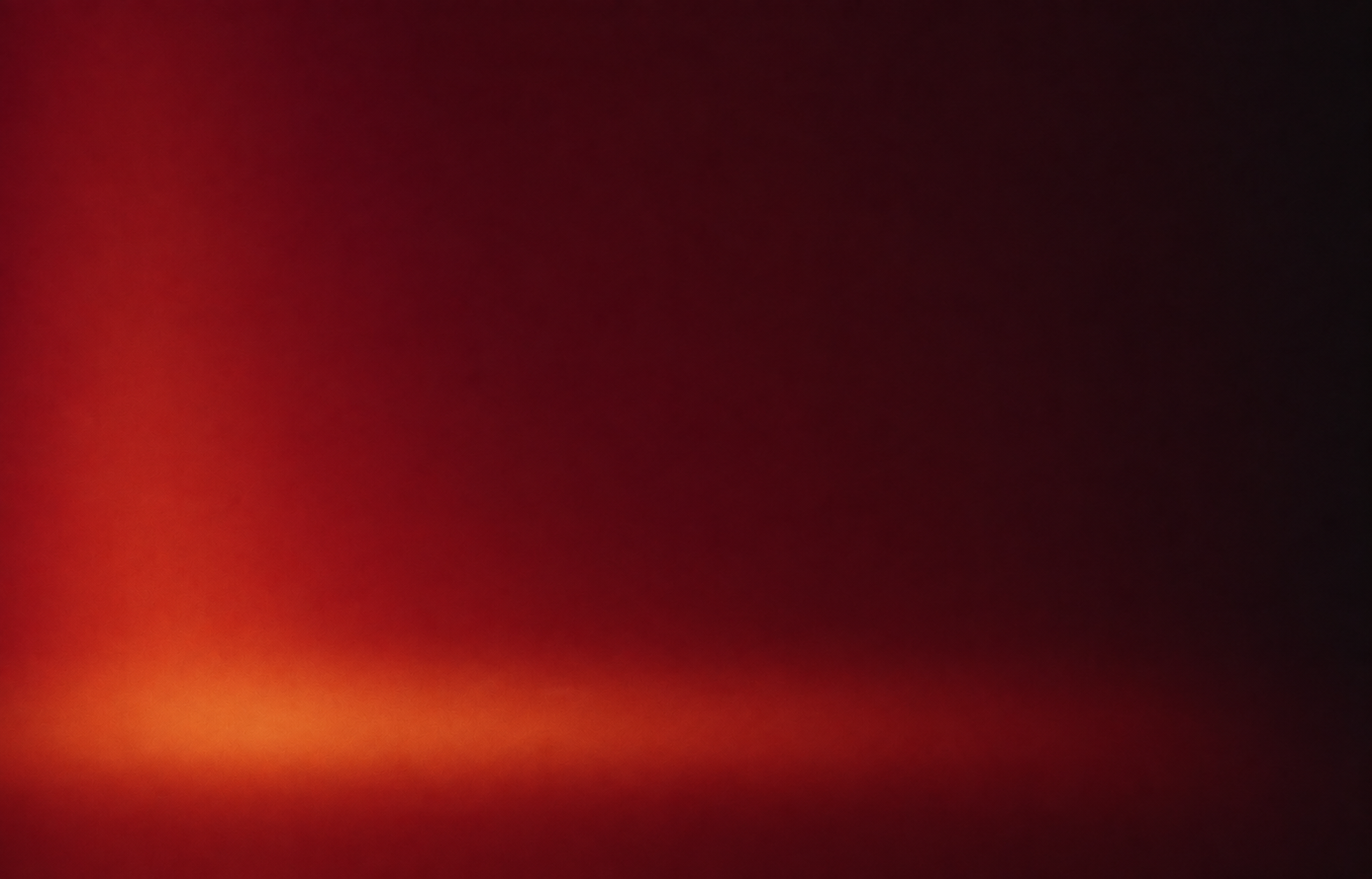 Warm red studio backdrop with a soft floor line
