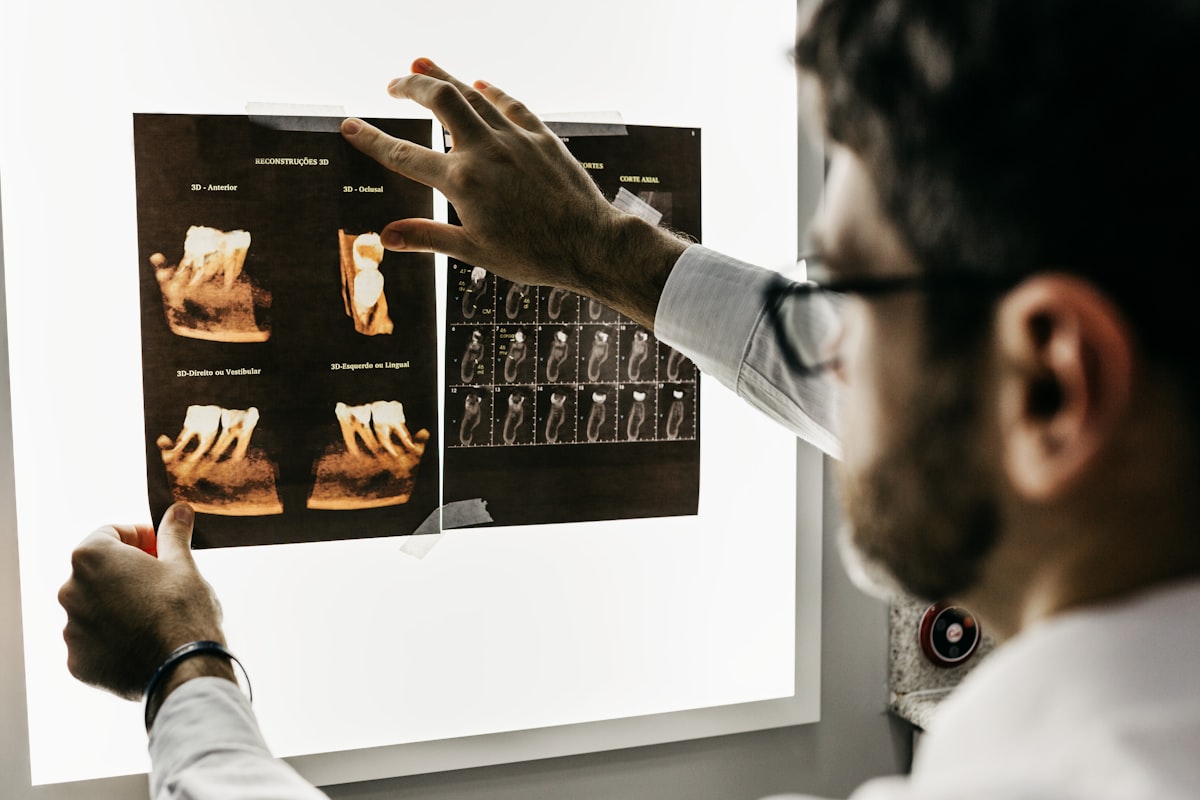 Dentist reviewing dental scans for surgery and emergency care